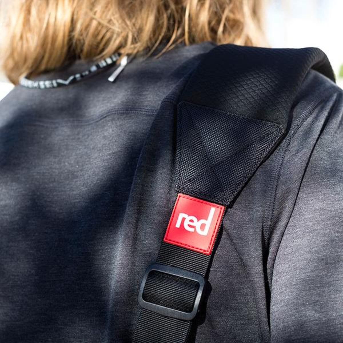 Red Original sup carry strap on the shoulder